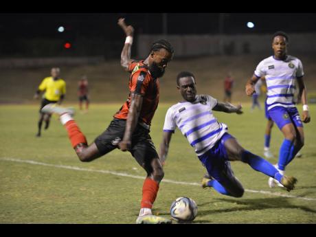 Kimani Arbouine (left) of Arnett Gardens in action against Vere United’s Jadon Anderson (centre) during a recent Jamaica Premier League match. 