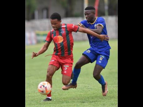 Montego Bay United’s Shaquille West (left) tries to avoid the challenge of Molynes United’s Sujae McBean.