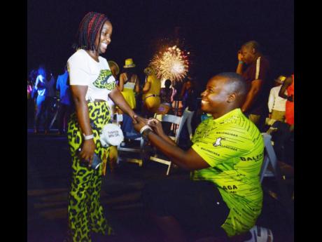 Narmeo Walker falls to his knees to propose to his girlfriend Tashanna McCourty as thousands rang in 2020 on the Kingston Waterfront. 