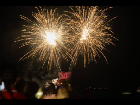 Fireworks light up the night sky as Jamaicans ring in 2024 by the Waterfront in downtown Kingston.