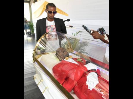 Nico Malcolm, Gully Bop’s son, looks on solemnly at his father.