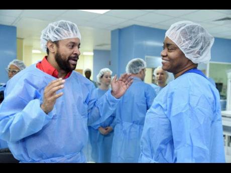 Orville ‘Shaggy’ Burrell (left), of the Shaggy Make a Difference Foundation, chats with Consultant Paediatric Cardiologist at the Bustamante Hospital for Children, Dr Sharonne Forrester, during a recent tour of the cardiac catheterisation lab at the institution, which was partially funded by the Foundation.