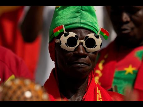 A Burkina Faso supporter waits for the second half during the African Cup of Nations Group D football match between Algeria and Burkina Faso at the Peace of Bouake stadium in Bouake, Ivory Coast on Saturday. The game ended in a 2-2 draw.