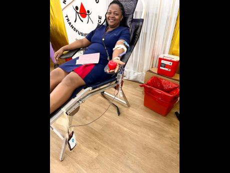 RJRGleaner Communications Group employee Kemecia Smith-Trew donates blood.