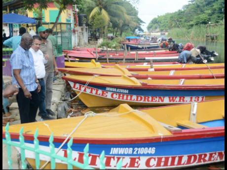 Minister of Local Government and Community Development, Desmond McKenzie (left), is joined by Minister without Portfolio in the Ministry of Economic Growth & Job Creation, Senator Matthew Samuda (second from left), and Ocho Rios Councillor, Michael Belnavis, in touring the White River Fisherman’s Village in St Ann.