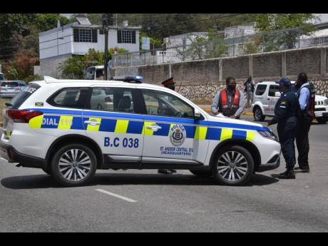 Credit: File A police service vehicle near the entrance to Nannyville, St Andrew.