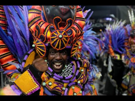 A performer from the Salgueiro samba school parades during Carnival celebrations at the Sambadrome in Rio de Janeiro, Brazil, yesterday.