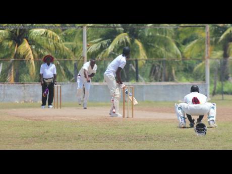 Veteran seamer Lascelles Davis (second left) picked up two wickets for Old Harbour in their win over Basement on Sunday. 
