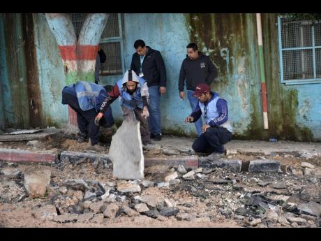Credit: AP Photos Workers remove rubble at the site where three Palestinians were killed by Israeli fire in Faraa refugee camp near the West Bank town of Tubas.