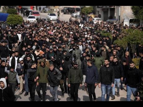 Credit: AP Majdi Mohammed Palestinian gunmen and mourners march ahead of Mohammed Daraghmeh, 26, and Muhammad Bayadsa 32, and Osama Zalat 31, during their funeral in the West Bank town of Tubas, Tuesday, Feb. 27, 2024. Israeli troops shot and killed three Palestinian men including Daraghmeh, a co-founder of the local branch of Islamic Jihad in the northern town of Tubas, early Tuesday, Palestinian health authorities said. Thee was no immediate comment from the Israeli military.