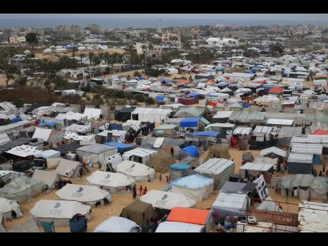 Credit: AP A tent camp housing Palestinians displaced by the Israeli offensive is seen in Rafah, Gaza Strip.