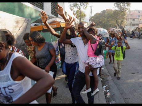 Residents flee their homes during clashes between police and gang members at the Portail neighbourhood in Port-au-Prince, Haiti, last Thursday.