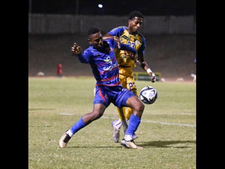 Credit: Ricardo Makyn Harbour View’s Rohan Brown (right) pressures Dunbeholden’s Zackiya Wilks during their Jamaica Premier League encounter at Stadium East last night. Dunbeholden won 3-0.