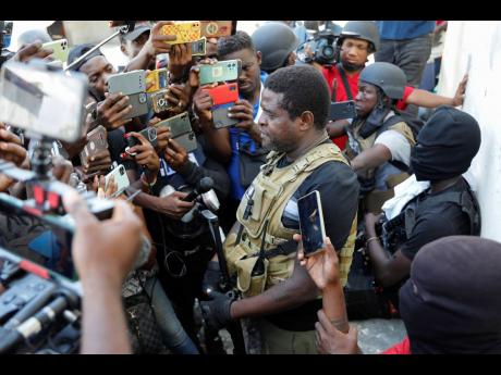 Jimmy Chérizier, a former elite police officer known as 'Barbecue' who now runs a gang federation, holds a press conference in the Delmas 6 neighborhood of Port-au-Prince, Haiti, last Tuesday.