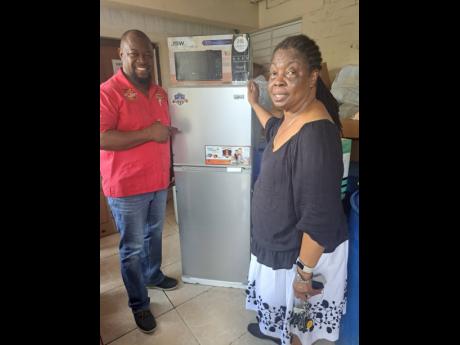 Dr Pauline Weir, medical officer for St Catherine, receives a refrigerator from businessman Marlon Morris at the St Jago Park Health Centre.