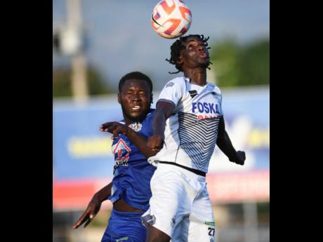 Portmore United’s Jaheim Rose battles with Cavalier’s Jerome McLeary during their Jamaica Premier League encounter at the Anthony Spaulding Sports Complex last night. Portmore won 1-0.
