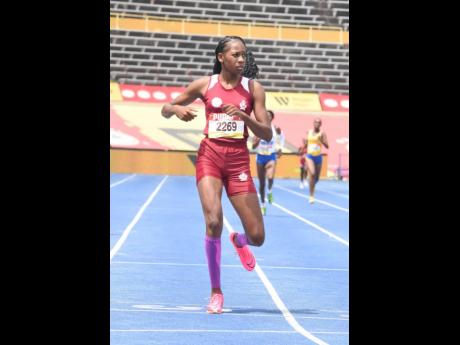 Credit: Ian Allen Muschette High's Shanoya Douglas eases after winning her heat in the Class Two girls' 400 metres at the ISSA/GraceKennedy Boys and Girls' Athletics Championships at the National Stadium today. Douglas finished in 53.39 seconds.