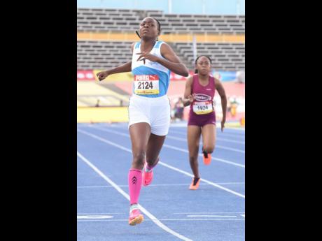 Sabrina Dockery of Lacovia High wins heat eight of the Class Two girls 100 metres. She ran under protest after she was taken out of heat three for false-starting. Dockery was later reinstated after an appeal.
