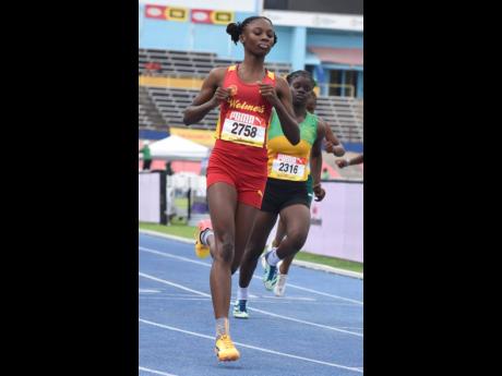 Natrece East of Wolmer’s Girls wins heat one of the Class Three girls’ 100 metres in 12.42 seconds.
