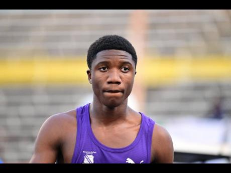 Credit: Gladstone Taylor Kingston College's Nyrone Wade is pensive after winning his Class Two boys' 100 metres semi-final at the ISSA/GraceKennedy Boys and Girls' Athletics Championships at the National Stadium today.