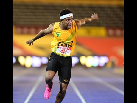 Credit: Gladstone Taylor Excelsior High’s Damor Miller dips to win the Class One boys' 100 metres title at the ISSA/GraceKennedy Boys and Girls' Athletics Championships at the National Stadium tonight.