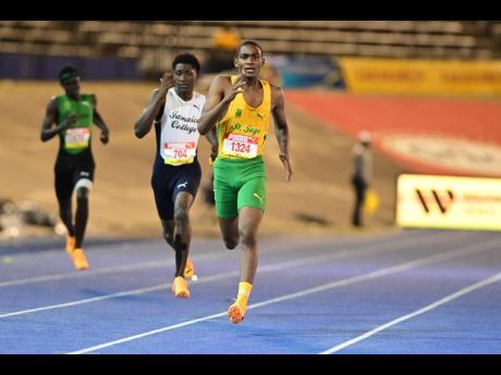 St Jago High School's Rushaine  Richards (right) storms to victory in the boys' Class 3 400 metres at the ISSA/GraceKennedy Boys and Girls' Athletics Championships inside the National Stadium this evening. 