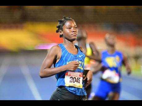 Hydel High's Teixiera Johnson looks at the clocks after winning the Class Four girls' 200 metres in 25.23 seconds at the ISSA/GraceKennedy Boys and Girls' Athletics Championships at the National Stadium tonight.