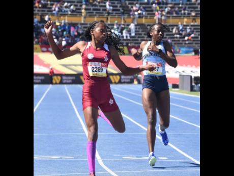 Muschett High’s Shanoya Douglas (left) eases at the finish line after defeating Edwin Allen High's Theianna-Lee Terrelonge to win the Class Two girls' 200 metres at the ISSA/GraceKennedy Boys and Girls’ Athletics Championships at the National Stadium today. Douglas clocked 23.93 seconds to Terrelonge's 24.31.