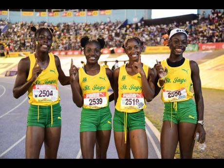 St. Jago High's Class Three girls 4x100 metres members celebrate their victory at the ISSA/Grace Kennedy Boys and Girls' Athletics Championships at the National Stadium tonight.