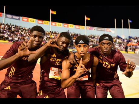Holmwood Technical's Open boys' sprint medley members celebrate their victory at the ISSA/GraceKennedy Boys and Girls' Athletics Championships at the National Stadium tonight.