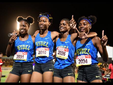 Hydel High's Open girls' 4x400 metres members celebrate their victory at the ISSA/GraceKennedy Boys and Girls' Athletics Championships at the National Stadium tonight.