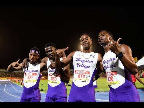 Kingston College's Open boys 4x400 members celebrate their victory at the ISSA/GraceKennedy Boys and Girls' Athletics Championships at the National Stadium tonight.