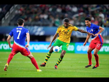 Jamaica’s Damion Lowe (centre) controls the ball while being surrounded by United States of America’s (USA) Malik Tillman (right) and Gio Reyna during the second half of their Concacaf Nations League semi-final football match on Thursday in Arlington, Texas, USA. The hosts won 3-1.