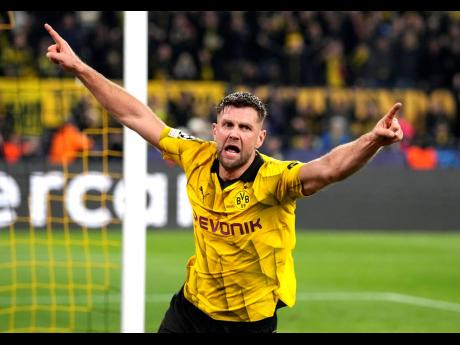 Dortmund’s Niclas Fuellkrug celebrates his side’s third goal during the Champions League quarterfinal second-leg match between Borussia Dortmund and Atletico Madrid at the Signal-Iduna Park in Dortmund, Germany, yesterday.