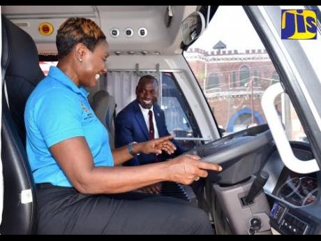 Juliet Cuthbert Flynn, state minister in the Ministry of National Security, familiarises herself with the features in one of the 12 new vehicles added to the Department of Correctional Services’ fleet. Looking on is Commissioner of Corrections, Brigadier (ret’d) Radgh Mason.