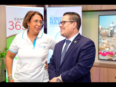 Minister without Portfolio in the Ministry of Economic Growth and Job Creation, Senator Matthew Samuda, converses with CEO of GraceKennedy Foundation, Caroline Mahfood, during Monday’s media launch of The Great Mangrove Clean-up, held at GraceKennedy Limited on Harbour Street in Kingston.