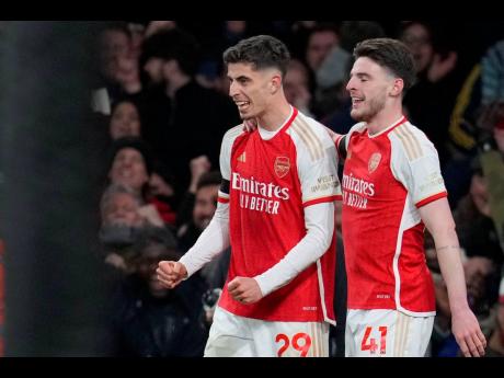 Arsenal’s Kai Havertz (left) celebrates with teammate Declan Rice after scoring his side’s third goal during the English Premier League match between Arsenal and Chelsea at Emirates Stadium in London yesterday.