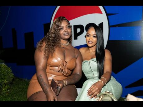 Hair stylists Ateeka Williams (left) and Jhade-Ann Gordon sitting pretty at the Pepsi logo launch.  