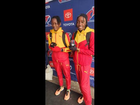 Wolmer’s Girls’ School’s Shaniqua Williams (left), winner of the girls’ high jump at the Penn Relays on Thursday, shares the moment with teammate Danielle Noble, who finished second.