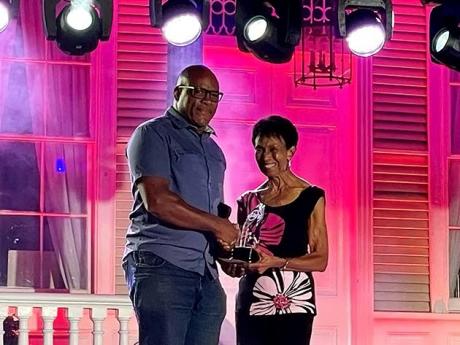 Credit: Contributed Melville Cooke accepting the Edward Baugh Prize for Poetry from Sheila Baugh on March 21, at Devon House on Waterloo Road, St Andrew.