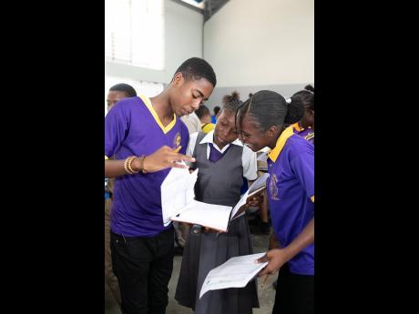 Students from Happy Grove High School comparing their budgets at the Credit Unions of Jamaica’s annual Financial Reality Fair.