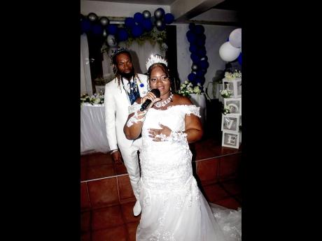 Diamond Kelly says a few words at her wedding reception as husband Black Blingaz looks on.