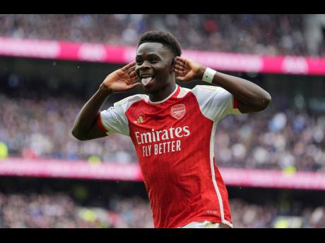 Arsenal’s Bukayo Saka celebrates after scoring their second goal during the English Premier League football match against Tottenham Hotspur at the Tottenham Hotspur Stadium in London, England, yesterday. Arsenal won 3-2.