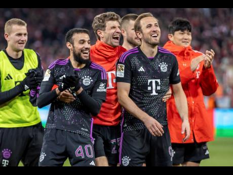 (From left) Noussair Mazraoui, Thomas Müller and Harry Kane of Bayern Munich celebrate in front of the crowd after the German Bundesliga football match against FC Union Berlin at the An der Alten Forsterei stadium in Berlin, Germany last Saturday. Bayern won 5-1.
