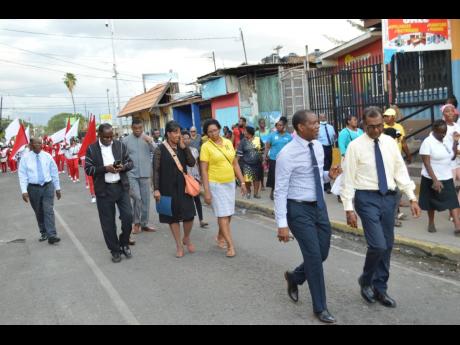 Members of the church community walking through Spanish Town to the mass meeting on Sunday night.