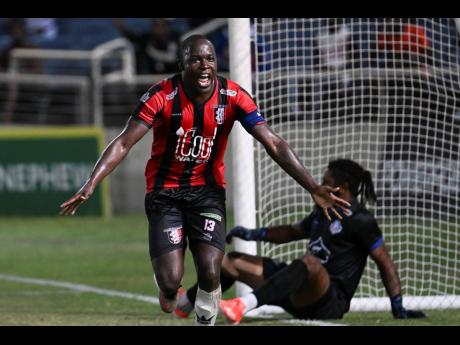 Credit: Arnett Gardens’ Fabian Reid leaves goalkeeper Tyrone Williams on the ground after scoring the only goal in their Jamaica Premier League quarter-final match against Portmore United at Sabina Park yesterday.