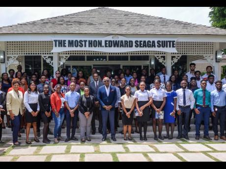 Minister of Tourism, Edmund Bartlett (centre), with tourism officials, representatives of companies and interns who participated in the 2023 Tourism Enhancement Fund Summer Internship Programme.