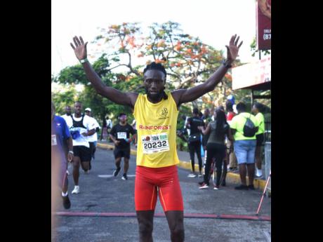 Kemar Leslie celebrates his 10K victory in the Jill Stewart MoBay City Run 10K/5K Run and Walk at the Old Hospital Park in Montego Bay, St. James, yesterday.