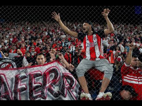 Argentina’s River Plate fans wait for the start of a Copa Libertadores Group H football match against Uruguay’s Nacional in Montevideo, Uruguay, on Tuesday.