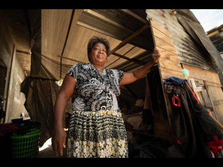 Credit: Gladstone Taylor Sandra Shepherd stands at the entrance of the wooden structure, covered with tarpaulin, that has called home for months.